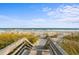 Wooden stairway leading down to a beautiful beach with ocean views at 6804 N Ocean Blvd. # 1127, Myrtle Beach, SC 29572