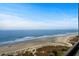 Expansive beach view from above, showcasing the ocean waves and sandy shoreline, ideal for relaxation at 6804 N Ocean Blvd. # 1127, Myrtle Beach, SC 29572