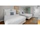 Bright bedroom featuring two beds with fresh white linens and coastal-themed decor at 6804 N Ocean Blvd. # 1127, Myrtle Beach, SC 29572