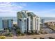 Attractive building showcasing its architecture with ocean backdrop and manicured landscaping at 6804 N Ocean Blvd. # 1127, Myrtle Beach, SC 29572