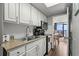 Well-equipped kitchen with stainless steel appliances, white cabinets, and granite countertops at 6804 N Ocean Blvd. # 1127, Myrtle Beach, SC 29572