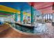 Bright and colorful indoor lazy river with lounge chairs and large windows at 6804 N Ocean Blvd. # 1127, Myrtle Beach, SC 29572