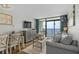 Comfortable living room featuring a cozy sofa, and balcony overlooking the ocean at 6804 N Ocean Blvd. # 1127, Myrtle Beach, SC 29572