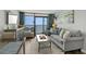 Comfortable living room featuring a cozy sofa, and balcony overlooking the ocean at 6804 N Ocean Blvd. # 1127, Myrtle Beach, SC 29572