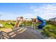 Outdoor playground on a grassy area with a climbing wall, swings and a slide at 6804 N Ocean Blvd. # 1127, Myrtle Beach, SC 29572