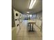 Bright laundry room with many machines and a folding table at 6900 N Ocean Blvd. # 1505, Myrtle Beach, SC 29572