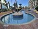 A lazy river with a decorative palm island in the middle and palm trees nearby at 6900 N Ocean Blvd. # 1505, Myrtle Beach, SC 29572