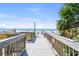 Beach access path with a wooden walkway and stairs leading to the sandy beach at 6900 N Ocean Blvd. # 735, Myrtle Beach, SC 29572