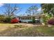 View of the backyard with a covered patio, garden beds, and well-maintained lawn at 708 48Th Ave. N, Myrtle Beach, SC 29577