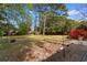 Lush backyard featuring mature trees, flower beds, and plenty of space for outdoor activities and gardening at 708 48Th Ave. N, Myrtle Beach, SC 29577