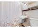 Cozy bathroom featuring a retro sink, decorative shower curtain, and tiled walls at 708 48Th Ave. N, Myrtle Beach, SC 29577