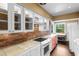 Efficient kitchen layout featuring white cabinets, tile countertops, and ample natural light at 708 48Th Ave. N, Myrtle Beach, SC 29577