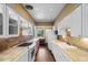 Galley kitchen with white cabinets, tile countertops, brick backsplash, and hardwood floors at 708 48Th Ave. N, Myrtle Beach, SC 29577