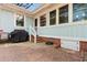 Quaint brick patio with charming string lights and a gas grill, perfect for outdoor dining and relaxing at 708 48Th Ave. N, Myrtle Beach, SC 29577
