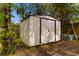 A sturdy outdoor shed nestled among mature trees, offering ample storage space at 708 48Th Ave. N, Myrtle Beach, SC 29577