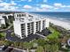 Aerial view of a condo building near the beach with a parking lot at 741 Retreat Beach Circle # B-1-F, Pawleys Island, SC 29585