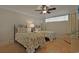 A bedroom with two twin beds with matching decorative linens, a ceiling fan and tile floors at 741 Retreat Beach Circle # B-1-F, Pawleys Island, SC 29585
