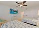 A bedroom with two twin beds, a ceiling fan and a flat screen television at 741 Retreat Beach Circle # B-1-F, Pawleys Island, SC 29585