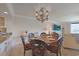 Charming dining room with a round table, elegant chandelier, and views into the living room and kitchen at 741 Retreat Beach Circle # B-1-F, Pawleys Island, SC 29585