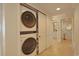 A hallway with a stacked washer and dryer and a view of a bathroom at 741 Retreat Beach Circle # B-1-F, Pawleys Island, SC 29585