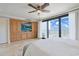 A spacious bedroom features a custom built-in cabinet, ceiling fan, and sliding glass doors at 741 Retreat Beach Circle # B-1-F, Pawleys Island, SC 29585