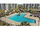 Aerial view of a community pool surrounded by lounge chairs and palm trees at 741 Retreat Beach Circle # B-1-F, Pawleys Island, SC 29585