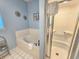 Bathroom featuring a jetted tub, shower and ocean-themed accents at 800 Castleford Circle # 1-E, Myrtle Beach, SC 29572