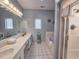 Bright bathroom with a double vanity, large mirror, and soaking tub at 800 Castleford Circle # 1-E, Myrtle Beach, SC 29572