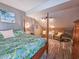 Bedroom featuring a four poster bed, ceiling fan and wicker seating area at 800 Castleford Circle # 1-E, Myrtle Beach, SC 29572