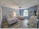 Bright bedroom featuring two beds, a ceiling fan, and a large window at 800 Castleford Circle # 1-E, Myrtle Beach, SC 29572