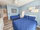 Comfortable bedroom featuring twin beds, light blue walls, wood floors, and coastal decor at 800 Castleford Circle # 1-E, Myrtle Beach, SC 29572