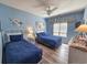 Charming bedroom featuring two twin beds, coastal decor, light blue walls, and wood floors at 800 Castleford Circle # 1-E, Myrtle Beach, SC 29572