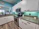 Well-lit kitchen features white cabinets, granite countertops, and stainless steel appliances at 800 Castleford Circle # 1-E, Myrtle Beach, SC 29572