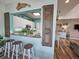 View of the kitchen and bar seating area featuring white cabinets and granite countertops at 800 Castleford Circle # 1-E, Myrtle Beach, SC 29572