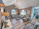 Bright living room with a vaulted ceiling, wood floors, lots of light and comfortable seating at 800 Castleford Circle # 1-E, Myrtle Beach, SC 29572