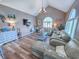 Spacious living room features vaulted ceiling, wood floors and a stylish chandelier at 800 Castleford Circle # 1-E, Myrtle Beach, SC 29572