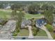Wide aerial perspective of the property, displaying the golf course setting, pond, and partially constructed home at 9278 Nw Checkerberry Square, Calabash, NC 28467