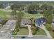 Scenic aerial view of the property, including a golf course, pond, and partially constructed adjacent home at 9278 Nw Checkerberry Square, Calabash, NC 28467