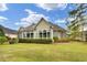 Picturesque backyard featuring a well-manicured lawn and an inviting sunroom for year-round enjoyment at 9278 Nw Checkerberry Square, Calabash, NC 28467