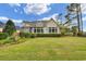Beautiful backyard with a spacious lawn and a charming sunroom, perfect for outdoor relaxation at 9278 Nw Checkerberry Square, Calabash, NC 28467