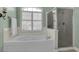 Serene bathroom features a soaking tub with shower and a glass-enclosed shower stall at 9278 Nw Checkerberry Square, Calabash, NC 28467