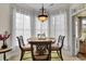 Charming breakfast nook featuring a bright chandelier, a round table, and great natural lighting at 9278 Nw Checkerberry Square, Calabash, NC 28467