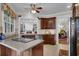 Open-concept kitchen with wooden cabinets and a center island, offering a seamless transition to the dining area at 9278 Nw Checkerberry Square, Calabash, NC 28467