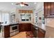 Traditional kitchen features stainless steel appliances and a garden window for natural light at 9278 Nw Checkerberry Square, Calabash, NC 28467