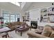 Bright living room showcasing a cozy fireplace, built-in bookshelves, and comfortable seating at 9278 Nw Checkerberry Square, Calabash, NC 28467