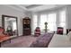 Bright main bedroom boasts a large mirror, sitting area, and a comfortable queen-sized bed at 9278 Nw Checkerberry Square, Calabash, NC 28467