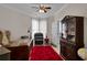 Comfortable home office with dark wood desk, leather chair, and display case for storage at 9278 Nw Checkerberry Square, Calabash, NC 28467