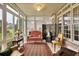 Bright sunroom filled with natural light, decorative screen, and an array of comfortable seating at 9278 Nw Checkerberry Square, Calabash, NC 28467
