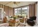 Inviting sunroom with neutral tones, wicker furniture, and large windows offering scenic outdoor views at 9278 Nw Checkerberry Square, Calabash, NC 28467