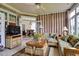 Cozy sunroom with wicker furnishings, large windows, and access to the dining area at 9278 Nw Checkerberry Square, Calabash, NC 28467